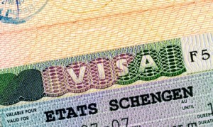 Schengen visa in passport closeup.